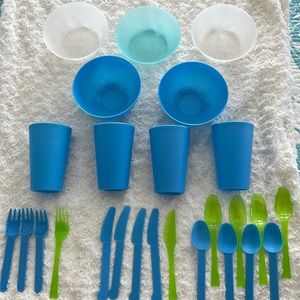 Lot of festive summer plastic bowls, cups, utensils.